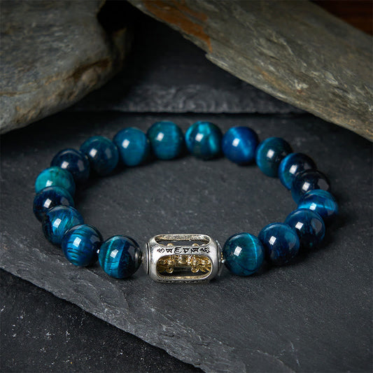Blue Tiger Eye Om Bracelet - beaded stretch bracelet on dark slate with Om Mani Padme Hum mantra charm, blue tiger eye healing bracelet