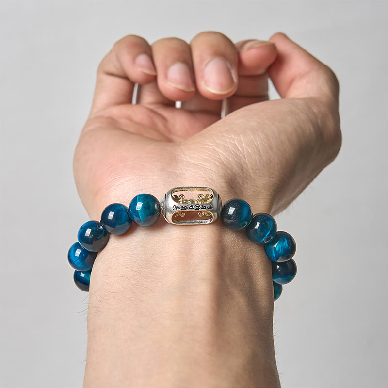 Blue Tiger Eye Bracelet on wrist - light background, dual-tone silver gold charm with detail engraving, mens meditation jewelry