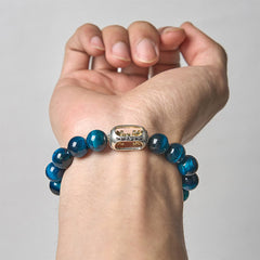 Blue Tiger Eye Bracelet on wrist - light background, dual-tone silver gold charm with detail engraving, mens meditation jewelry