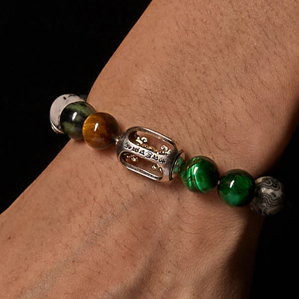 Grey Jasper Tiger Eye Bracelet – Worn on wrist on black background showing gold mantra charm, healing bracelet