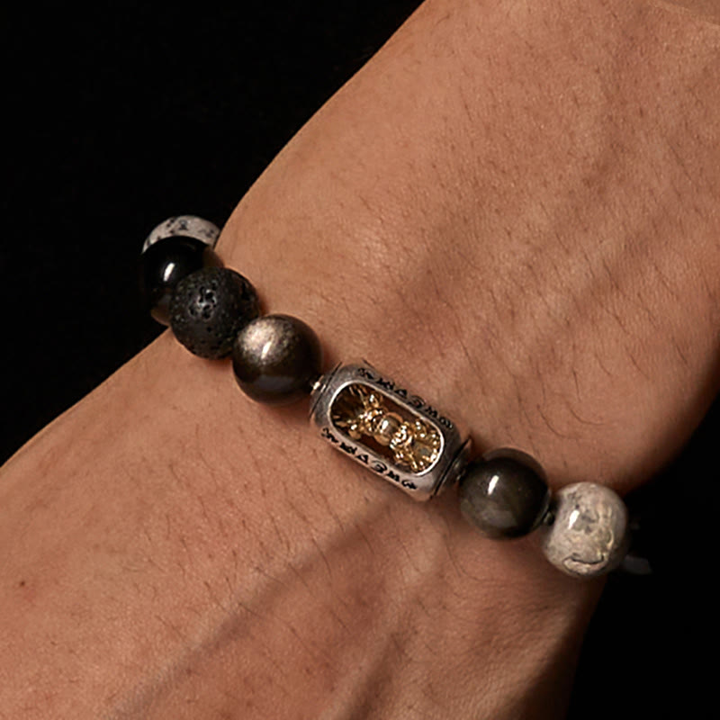 Silver Sheen Obsidian Lava Rock Vajra Bracelet – Macro wrist shot highlighting gold charm, lava stone bracelet