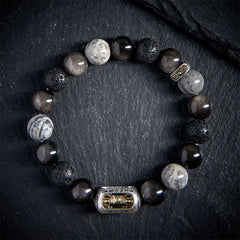 Silver Sheen Obsidian Lava Rock Vajra Bracelet – Overhead view on slate, obsidian lava bead bracelet