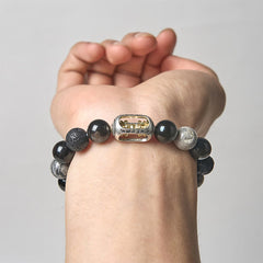 Silver Sheen Obsidian Lava Rock Vajra Bracelet – Worn on wrist showing gear charm, men’s protective jewelry