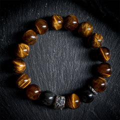 Tiger Eye Silver Sheen Obsidian Buddha Bracelet – flat-lay dark stone circle tiger eye obsidian silver Buddha bead, flatlay