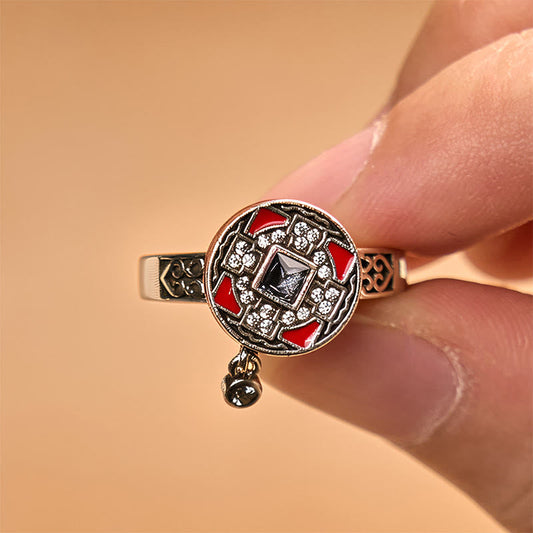 Copper Prayer Wheel Ring - Hand-held close-up revealing pavé halo and square dark center gemstone, vintage statement ring