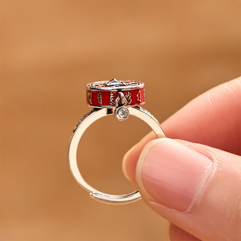 Copper Prayer Wheel Ring - Side profile showing spinning red enamel barrel with gold script and dangling stone, spinner ring
