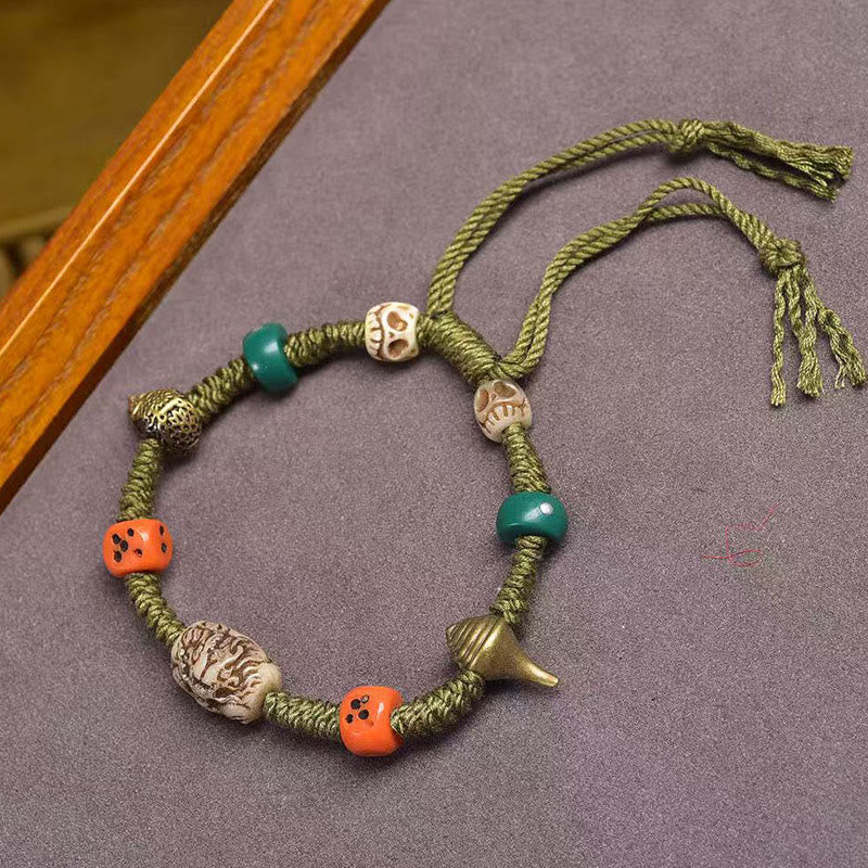 Tibetan Dragon Dice Bone Rope Bracelet – full laydown on gray felt with skull and dice beads, Handmade