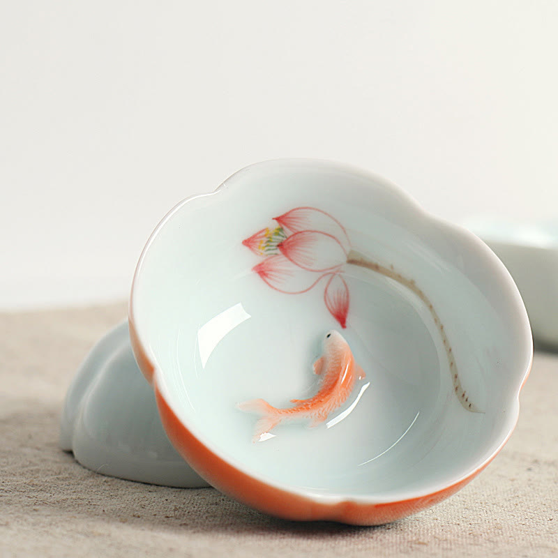 Koi Fish & Lotus Tea Cup – Tilted view of koi and lotus interior on linen fabric, ceramic tea cup