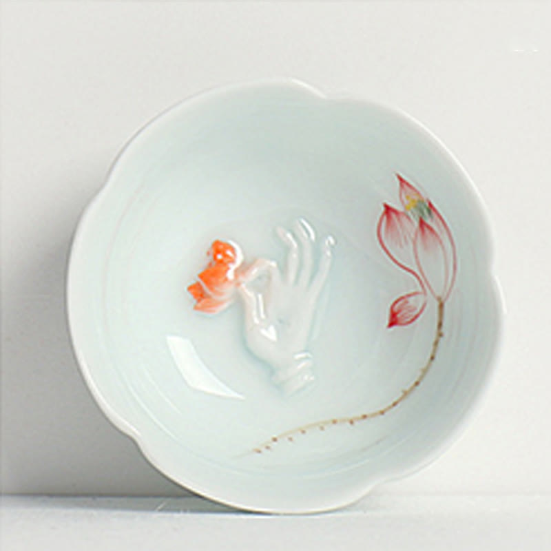 Koi Fish & Lotus Tea Cup – Tilted foot ring view of celadon cup with petal rim, artisan tea cup