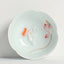 Koi Fish & Lotus Tea Cup – Tilted foot ring view of celadon cup with petal rim, artisan tea cup