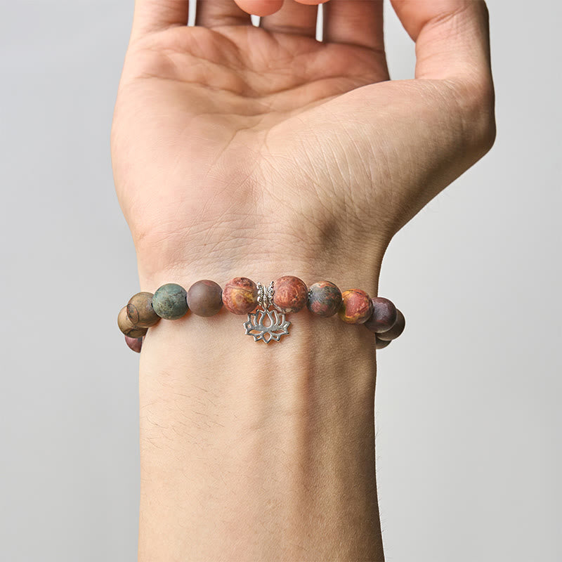 Picasso Jasper Lotus Bracelet – worn on wrist showing earthy jasper beads and silver lotus charm, gemstone