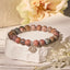 Picasso Jasper Lotus Bracelet – earthy beaded bracelet on white stone with dried flowers, jasper healing bracelet