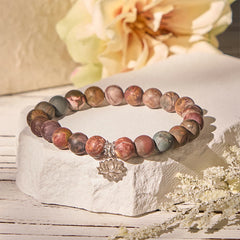 Picasso Jasper Lotus Bracelet – earthy beaded bracelet on white stone with dried flowers, jasper healing bracelet