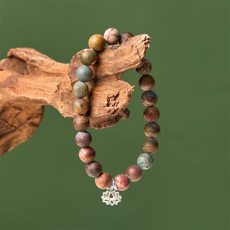 Picasso Jasper Lotus Bracelet – draped on driftwood against sage backdrop, multicolor stone bracelet