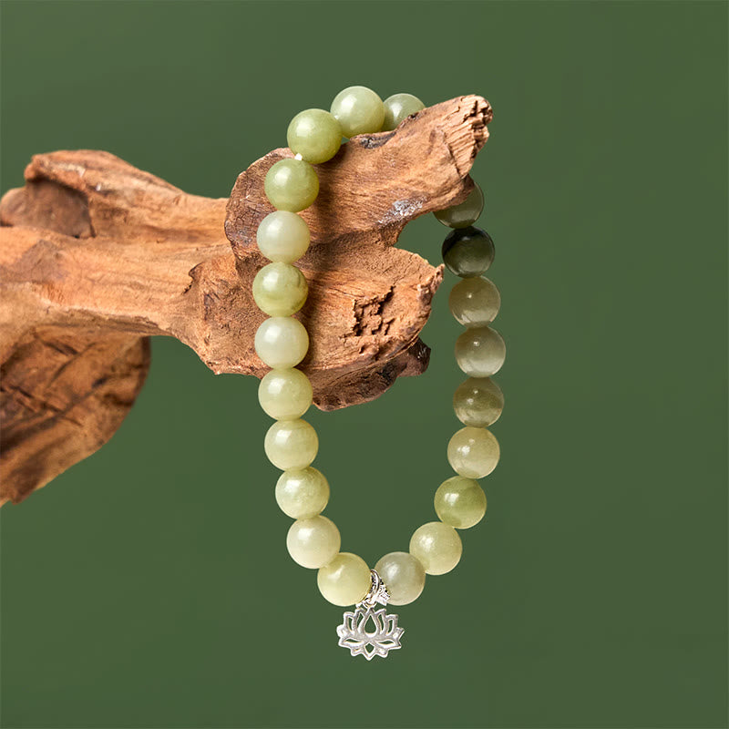 Green Jade Lotus Bracelet draped on driftwood, natural stone wrist jewelry