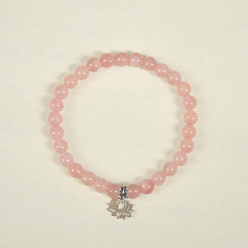 Natural Pink Crystal Bracelet overhead view with dangling lotus silver pendant