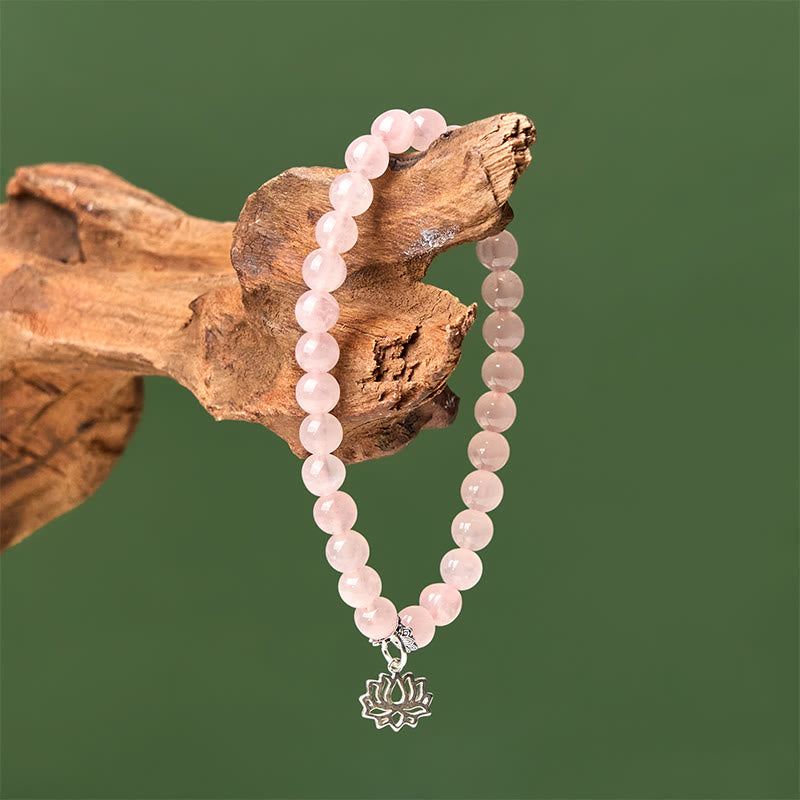 Pink Crystal Lotus Bracelet on weathered wood, natural rose quartz wrist jewelry