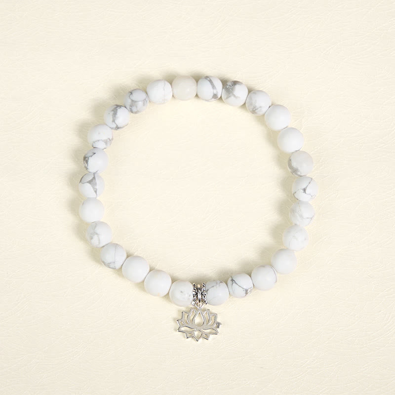 White Turquoise Lotus Bracelet – overhead flat lay, circular bead arrangement, silver lotus charm, turquoise bracelet