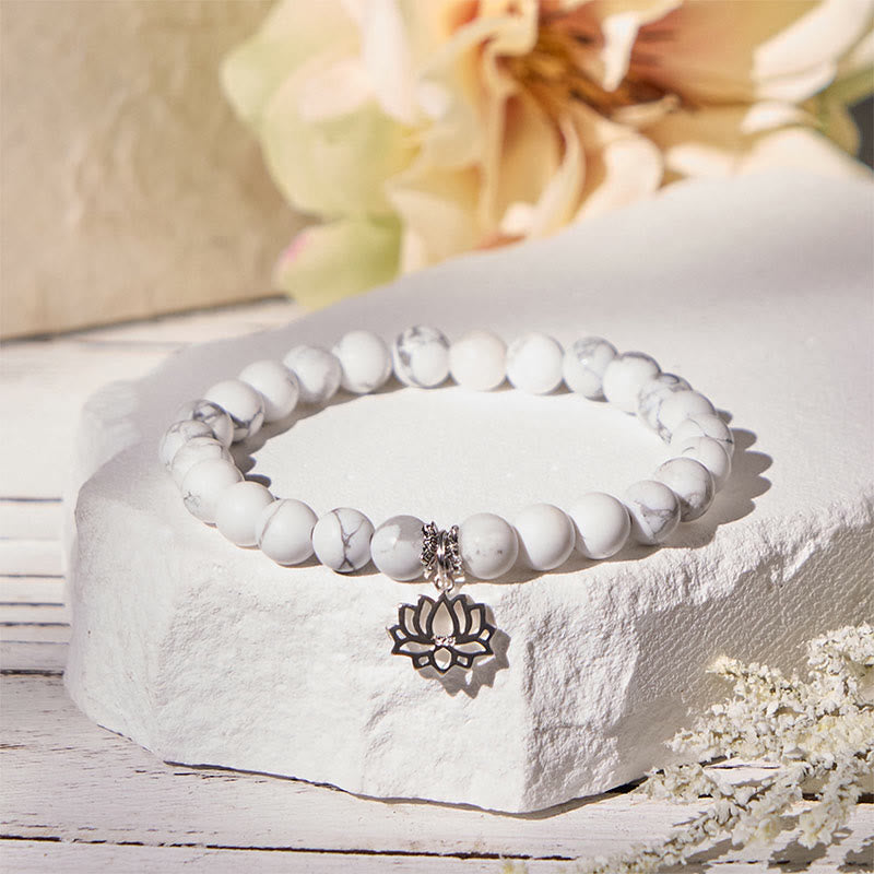 White Turquoise Lotus Bracelet – on stone pedestal with cream flowers, silver lotus charm detail, natural stone bracelet