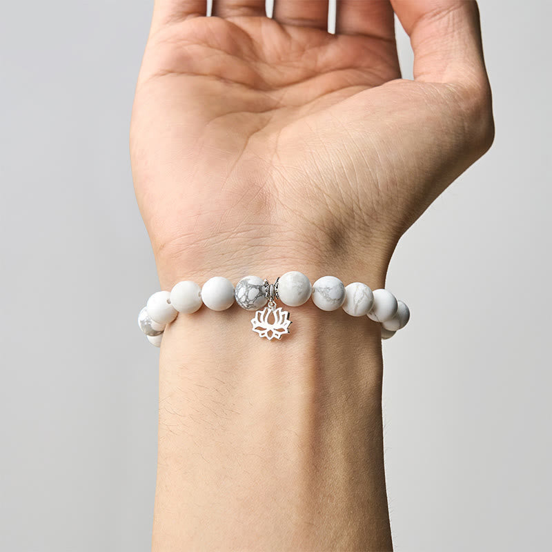 White Turquoise Lotus Bracelet – on wrist inner view, silver lotus charm facing up, natural stone stretch bracelet