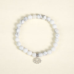 White Turquoise Lotus Bracelet – overhead flat lay, circular bead arrangement, silver lotus charm, turquoise bracelet