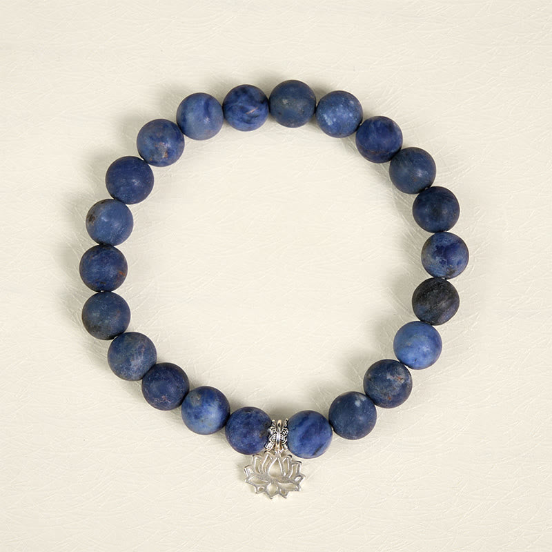Sodalite Lotus Bracelet – top-down view of blue sodalite beads with silver lotus charm, natural stone bracelet