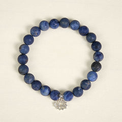 Sodalite Lotus Bracelet – top-down view of blue sodalite beads with silver lotus charm, natural stone bracelet