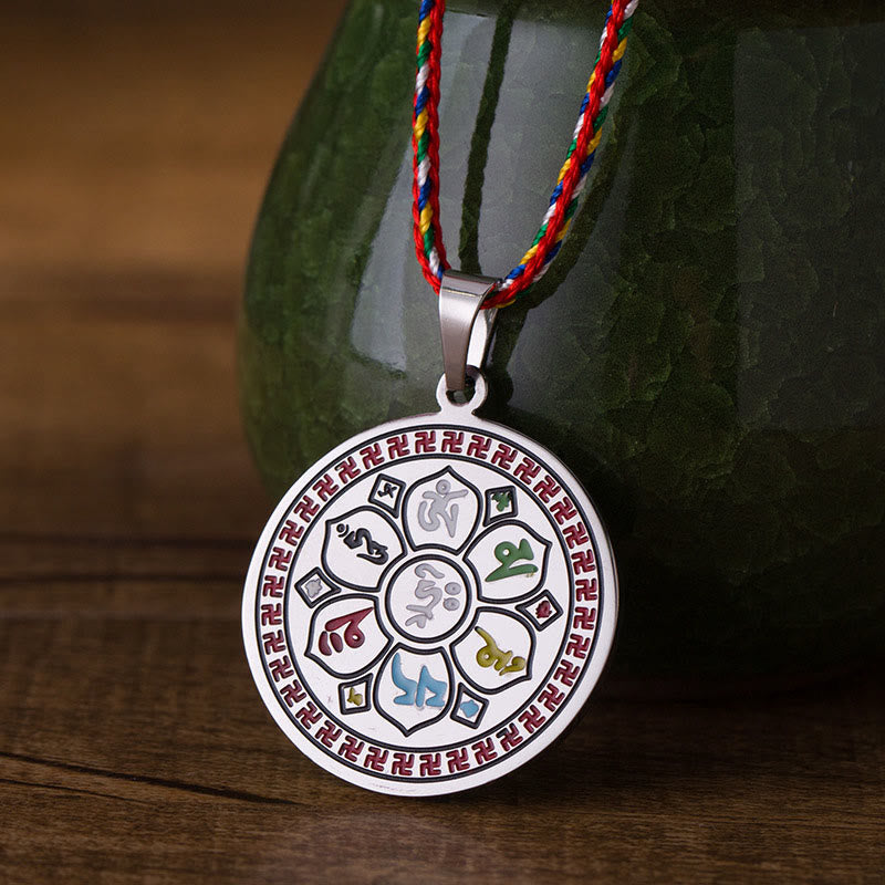 Om Mani Padme Hum Pendant Necklace – colorful cord pendant hanging before green ceramic on wood, Buddhist spiritual jewelry Hauptbild