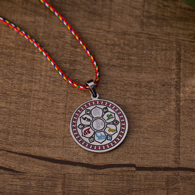 Om Mani Padme Hum Pendant Necklace – lotus flower mantra disc resting on natural wood grain, Zen meditation jewelry