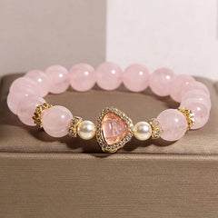 Pink Crystal Pearl Buddha Bracelet – front view pink crystal beads, pearl accents, Buddha charm with gold border, studio