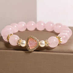 Pink Crystal Pearl Buddha Bracelet – front view pink crystal spheres, pearls and diamond-studded gold Buddha charm, closeup