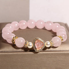 Pink Crystal Pearl Buddha Bracelet – closeup front showing smooth pink crystal beads and Buddha centerpiece, macro