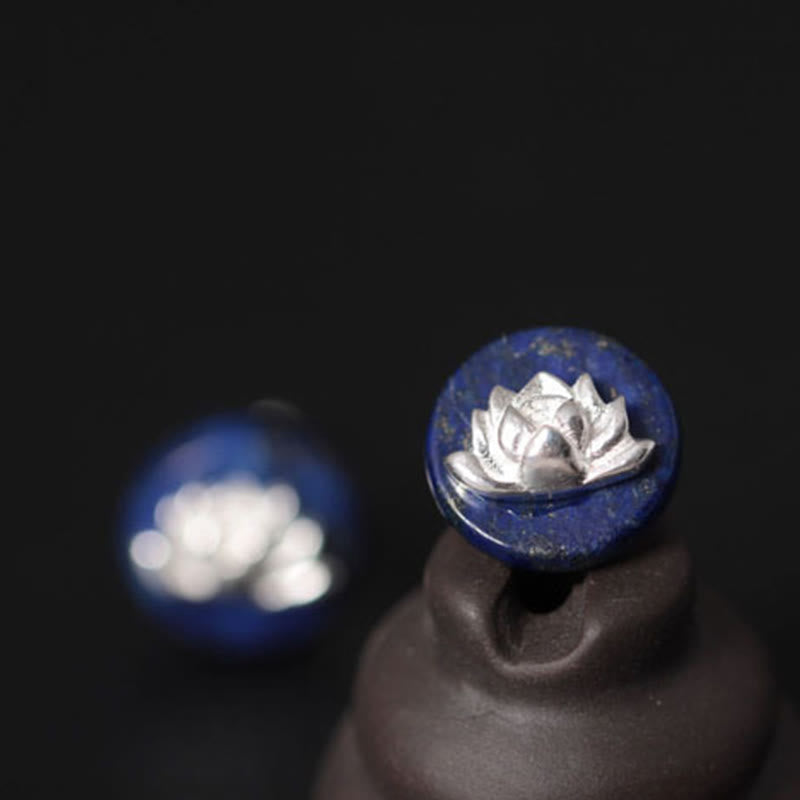 Sterling Silver Lotus Earrings – displayed on ceramic stand, lapis lazuli cabochon with silver lotus overlay