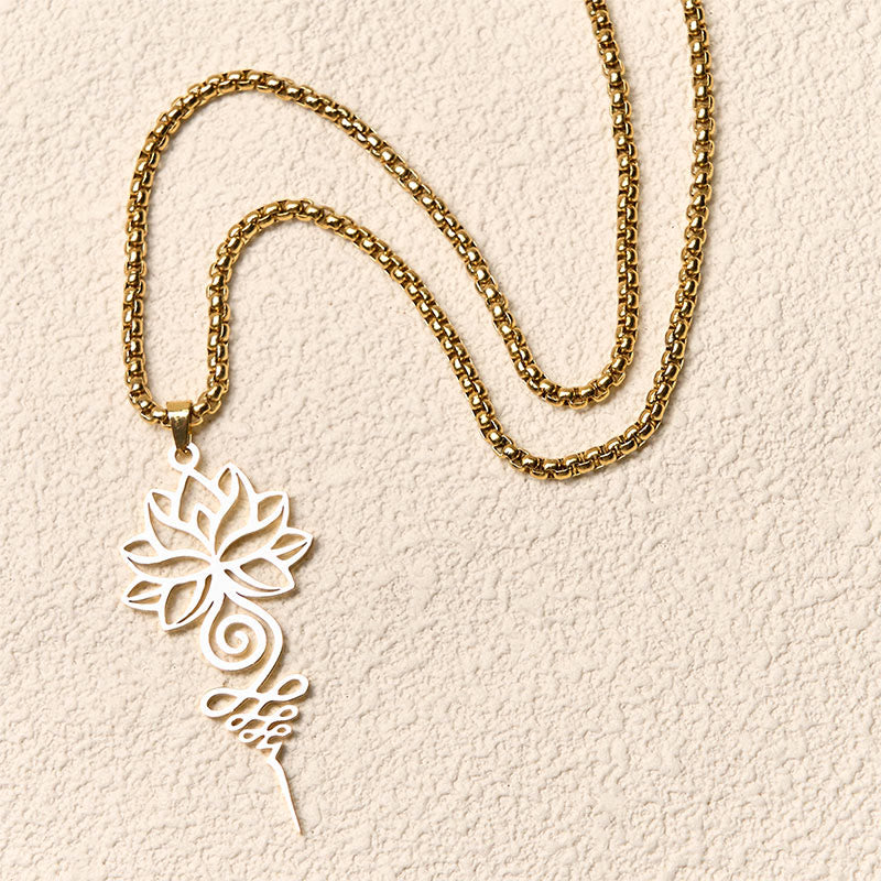 Lotus Unalome Necklace – Gold openwork lotus-unalome pendant flat-laid on cream, enlightenment jewelry