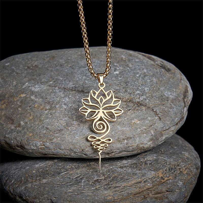 Lotus Unalome Necklace – Gold lotus-unalome pendant on black stone background, spiritual enlightenment jewelry
