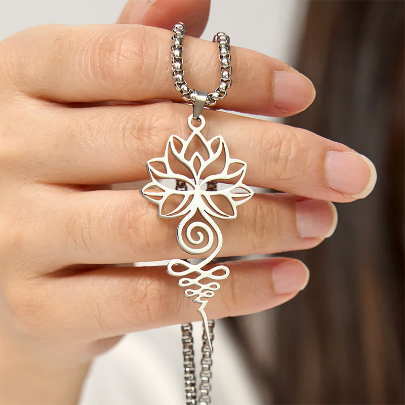 Lotus Unalome Necklace – Silver lotus-unalome pendant held in hand showing scale, spiritual chakra jewelry