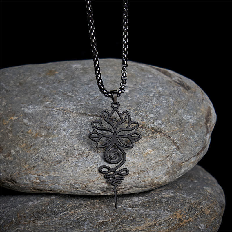 Lotus Unalome Chakra Necklace – Black gunmetal lotus-unalome pendant on stones, spiritual awakening jewelry