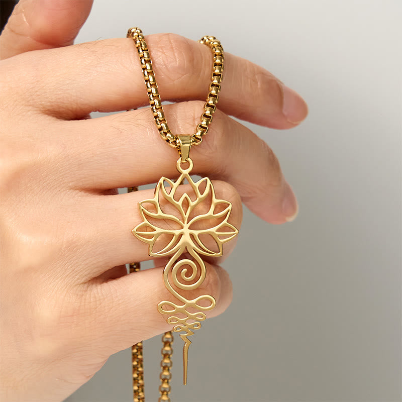 Lotus Unalome Chakra Necklace – Gold lotus-unalome pendant held in hand close-up, spiritual mindfulness jewelry