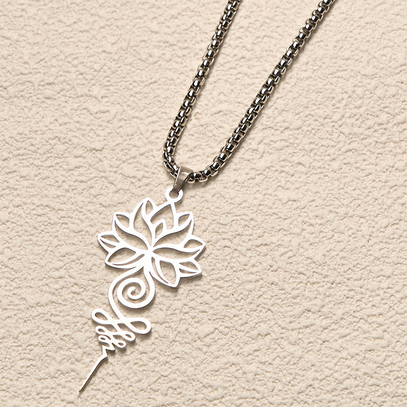 Lotus Unalome Chakra Necklace – Silver openwork lotus and unalome on cream background, chakra jewelry