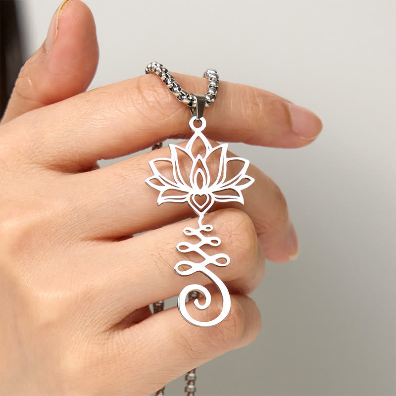 Chakra Lotus Necklace – Silver lotus-unalome pendant held in hand for scale, enlightenment jewelry