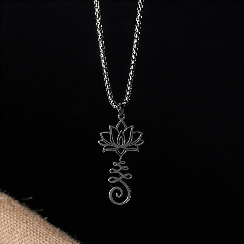 Chakra Lotus Necklace – Black lotus heart pendant on dark backdrop with fabric accent, spiritual necklace