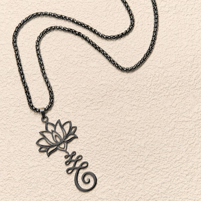 Chakra Lotus Necklace – Black lotus vine pendant in flat lay on neutral background, chakra jewelry