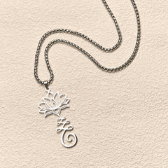Chakra Lotus Necklace – Silver lotus-love script pendant in flat lay, chakra love necklace