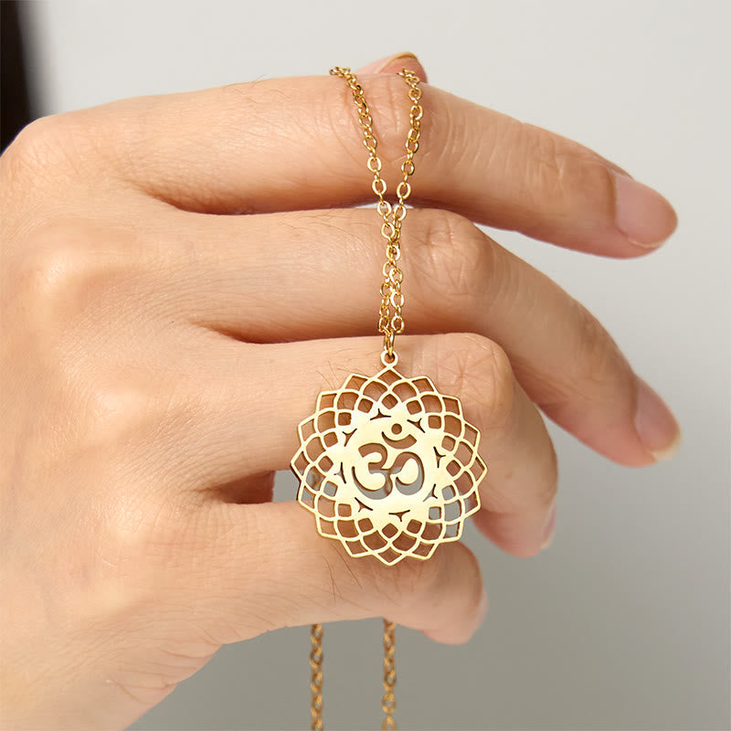 Gold Om lotus pendant held in hand, mandala yoga necklace