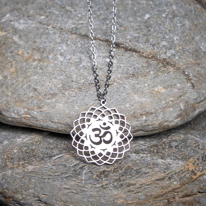 Silver Om mandala lotus pendant on gray slate, spiritual necklace