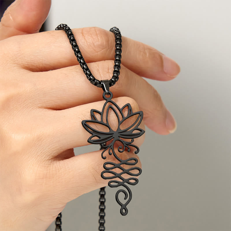 Lotus Vines Chakra Necklace – Black lotus-unalome pendant held in hand showing size, spiritual necklace