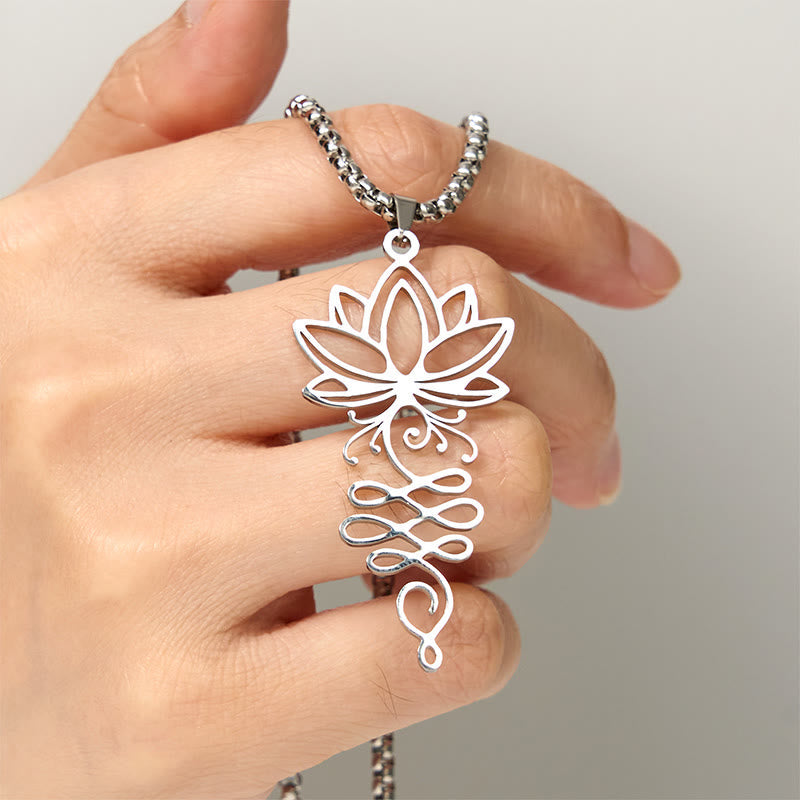 Lotus Vines Chakra Necklace – Silver lotus-unalome pendant held in hand showing scale, chakra jewelry