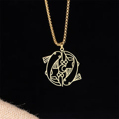 Vintage Koi Fish Hollow Luck Necklace – gold yin-yang koi pendant, front view on black with burlap accent