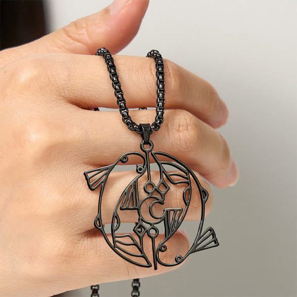 Vintage Koi Fish Hollow Luck Necklace – black koi pendant held in hand, neutral gradient background