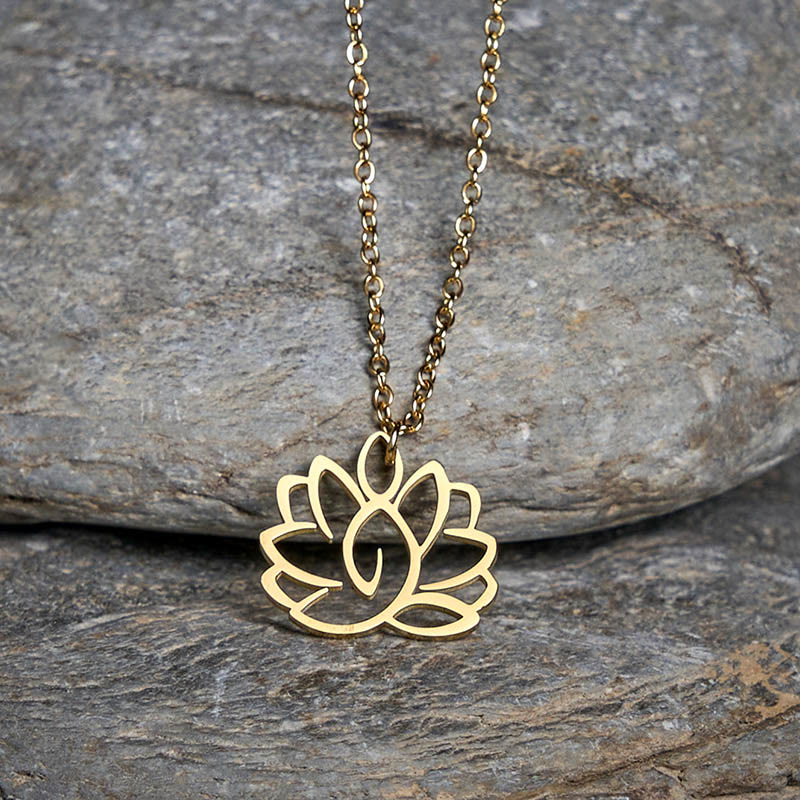 Hollow Lotus Necklace – Gold lotus pendant over natural stone surface, purity enlightenment necklace